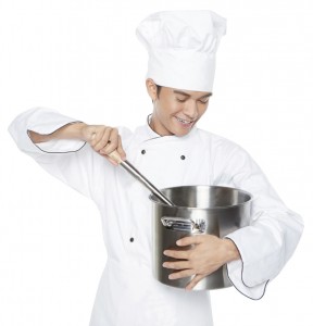Male chef stirring food in the pot