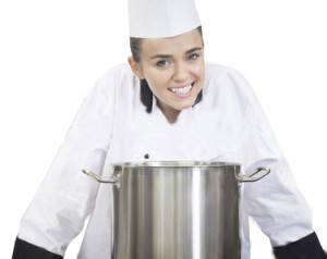 depositphotos_36188139-Young-smiling-chef-standing-behind-saucepan